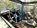 Steering Wheel and View Inside an Abandoned Old Car in the Desert Royalty Free Stock Photo