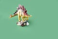 Stegosaurus dinosaurs toy on stones on green background Royalty Free Stock Photo