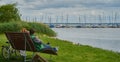 Couple relaxing on a bench eating ice cream and enjoying the view of the lake