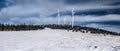 Steinriegel hill with wind turbines in winter Fischbacher Alpen mountains in Styria