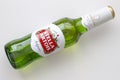 A Stella Artois beer bottle lay down on a white table