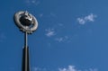 A monument of the Soviet era hammer and sickle on the background of blue sky Royalty Free Stock Photo