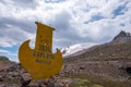 Stella on the road to Kumtor gold mine with inscription in Kyrgyz language -