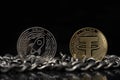 Stellar Lumens XLM And Tether USDT Crypto coins placed on silver chain in the black background.