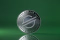 Stellar XLM Crypto coin placed on reflective surface and lit with the green light Royalty Free Stock Photo