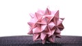 Stellated origami ball on white background.