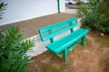 Minty green bench standing near a white building in Stellenbosch.