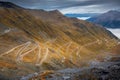 Stelvio pass, mountain road dramatic landscape at dawn above mist, Italy
