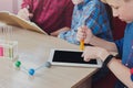 Boy studying with tablet and lab equipment Royalty Free Stock Photo