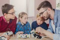 Stem education. Kids creating robots with teacher Royalty Free Stock Photo