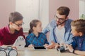 Stem education. Kids creating robots with teacher Royalty Free Stock Photo