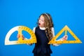 STEM school disciplines. Pupil girl with big rulers. small girl back to school. School student learning geometry. math Royalty Free Stock Photo