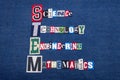 STEM SCIENCE TECHNOLOGY ENGINEERING and MATHEMATICS text word collage, colorful fabric on blue denim, education concept Royalty Free Stock Photo