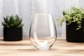 Stemless wine glass mockup with Christmas elements in background. Generative AI Royalty Free Stock Photo