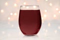 Stemless wine glass mockup with red wine and lights Royalty Free Stock Photo