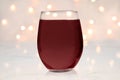 Stemless wine glass mockup with red wine and lights