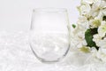 Stemless wineglass mockup with white flowers