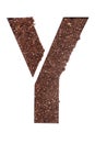 Stencil letter Y made above dirt on white surface