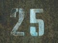 Stenciled numbers 25 on a brown rusty background