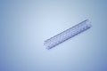 A stent used in angioplasty procedure placed on a white surface