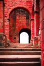 Step and arched doorways on red brick medieval ancient ruins