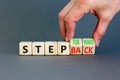 Step back or forward symbol. Concept words Step back Step Forward on wooden cubes. Beautiful grey table grey background.