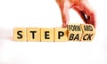 Step back or forward symbol. Concept words Step back Step Forward on wooden cubes. Beautiful white table white background.