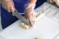 Step by step, baker prepares bread. baker slaps on dough. making bread, hands cutting dough before cooking, male baker hands Royalty Free Stock Photo