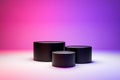 3 step Blank black cylinder podium in dark studio with red and purple LED light Royalty Free Stock Photo