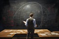 Back View of Young Teacher Looking at Blackboard with Graphs and Diagrams