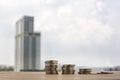 Step of coins stacks, gold coins on blurred building background