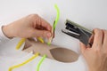 step in creative process, Attaching Pipe Cleaner, A person using a stapler to attach a pipe cleaner to one of the cut Royalty Free Stock Photo