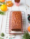 Step-by-step decoration of a carrot cake with chocolate glaze, ganache and candied fruits in a Christmas style on a light wooden Royalty Free Stock Photo