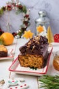 Step-by-step decoration of a carrot cake with chocolate glaze, ganache and candied fruits in a Christmas style on a light wooden Royalty Free Stock Photo