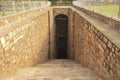 Step going down towards old well which is used for storage of water