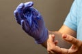 Step of hand throwing away blue disposable gloves medical, Isolated on white background. Infection control concept