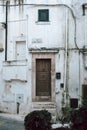 Step into History with Ostuni\'s White Building Stunning Wooden Door with Antique Charm