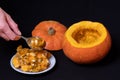 Step 2 Hollowing out the pumpkin, removing the seeds with a spoon to prepare the Jack Lantern Royalty Free Stock Photo