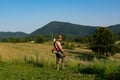 Rural Serenity: Farmer Taming the Tall Grass with Trimmer at Sunset