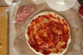 Step-by-step instructions for cooking pizza. Step 1. Roll the dough onto the dough and spread the tomato sauce. Dough with red Royalty Free Stock Photo