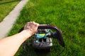 Step 1. step-by-Step instructions on how to mow the grass with a Makita electric lawn mower. Click on the red button and hold the