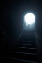 Step Into The Light. Dark stone hallway with a upward staircase leading into the light and fog. Royalty Free Stock Photo