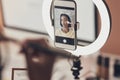 Step one of any makeup routine Apply self confidence. a young woman applying makeup while filming a beauty tutorial at