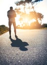 Step out of your shadow to find your strength. a young man looking defeated while out for a run.