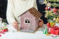 Step-by-step photo instructions for making a Christmas decor - a cardboard house, step 6 - applying white paint to the bricks with