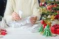 Step-by-step photo instructions for making Christmas paper decor, step 3 - connect teardrop-shaped elements onto a strip