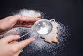 Step 6 of 6. Powdered sugar scattered on a black stone countertop. Royalty Free Stock Photo
