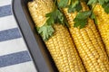 Step by step recipe. Home cooking baked corn in foil. Step 1 raw corn cobs on baking sheet. Homemade food concept. Vegetarian Royalty Free Stock Photo