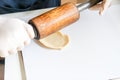 Step by step, baker prepares bread. baker slaps on dough. making bread, hand with rolling pin and flour