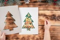 Step-by-step Greeting card Christmas tree with children`s fingerprints tutorial. Step 8: Carefully remove stencil Royalty Free Stock Photo